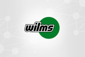 Wilms company logo with a green circle on a light background.